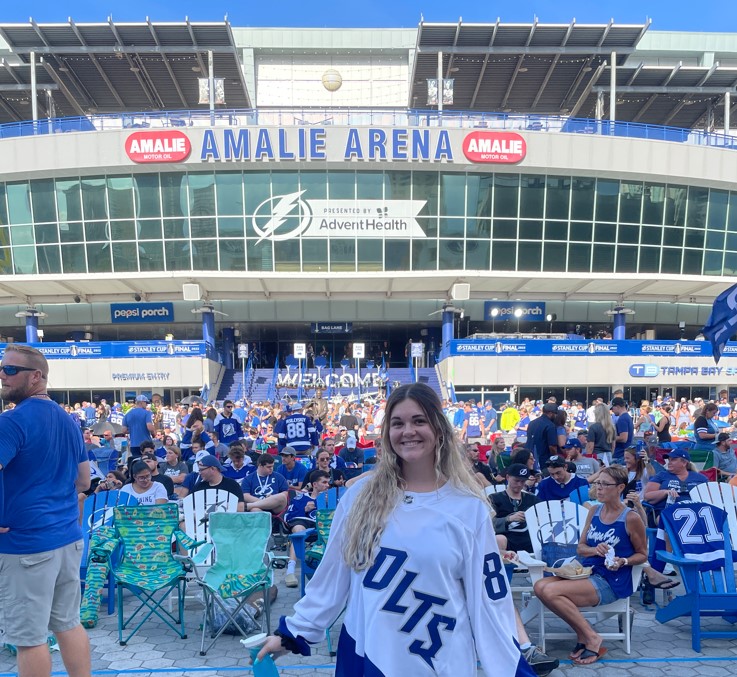 Blonde girl standing in front of Amalie Arena in Tampa, FL