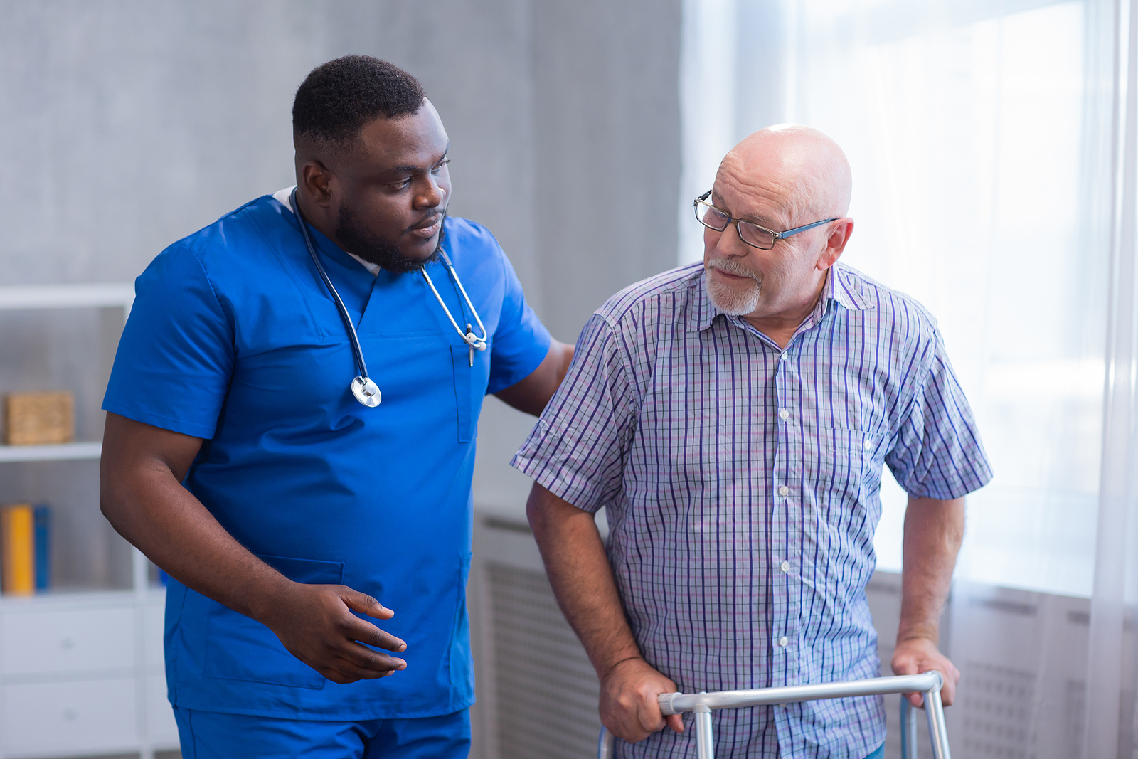 travel nurse helping older patient